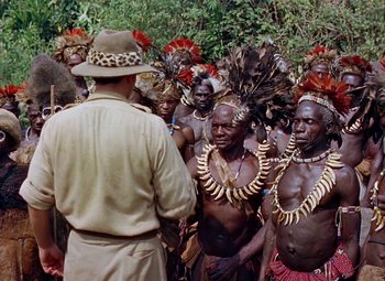Movie still from “King Solomon's Mines” (1950), directed by Andrew Marton – A group of men in traditional african clothing and headdresses; Medium shot, High angle