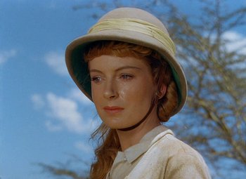 Movie still from “King Solomon's Mines” (1950), directed by Andrew Marton – A woman wearing a hat in front of a tree; Close Up shot, Low angle
