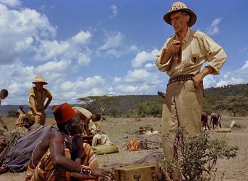 Movie still from “King Solomon's Mines” (1950), directed by Andrew Marton – An old man standing next to an older man in the desert; Medium shot, Low angle