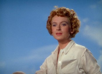 Movie still from “King Solomon's Mines” (1950), directed by Andrew Marton – A woman in a white shirt is standing in front of a blue sky; Close Up shot, Low angle