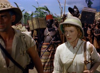 Movie still from “King Solomon's Mines” (1950), directed by Andrew Marton – A group of people walking down a street; Medium shot, Over the shoulder angle