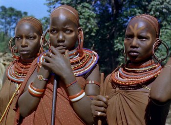 Movie still from “King Solomon's Mines” (1950), directed by Andrew Marton – A group of women standing next to each other in front of trees; Close Up shot, Low angle