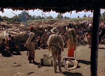 Movie still from “King Solomon's Mines” (1950), directed by Andrew Marton – A group of people standing in front of a crowd; Wide shot, High angle
