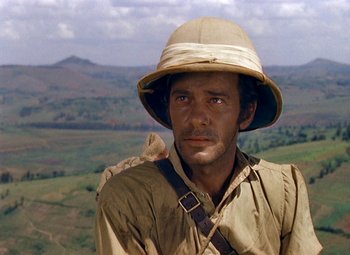 Movie still from “King Solomon's Mines” (1950), directed by Andrew Marton – A man wearing a hat with a bird perched on his shoulder; Close Up shot, Low angle