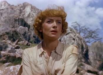 Movie still from “King Solomon's Mines” (1950), directed by Andrew Marton – A person wearing a white shirt near a mountain; Close Up shot, Low angle
