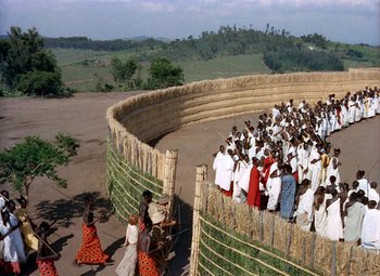 Movie still from “King Solomon's Mines” (1950), directed by Andrew Marton – A group of people standing around a fence; Extreme Wide shot, High angle