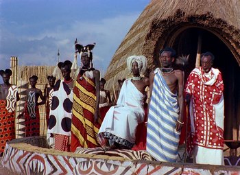 Movie still from “King Solomon's Mines” (1950), directed by Andrew Marton – A group of people standing in front of a building; Wide shot, Low angle