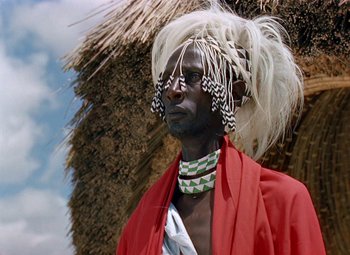 Movie still from “King Solomon's Mines” (1950), directed by Andrew Marton – A man with a red jacket and a white wig; Close Up shot, Low angle