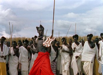 Movie still from “King Solomon's Mines” (1950), directed by Andrew Marton – A group of men in white and red clothes; Wide shot, Low angle