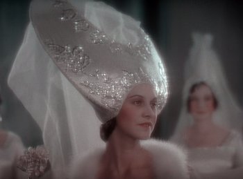 Movie still from “King of Jazz” (1930), directed by Walter Lantz – A person wearing a hat; Close Up shot, Low angle