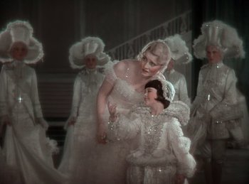 Movie still from “King of Jazz” (1930), directed by Walter Lantz – A group of people dressed up in fancy clothing; Medium shot, High angle