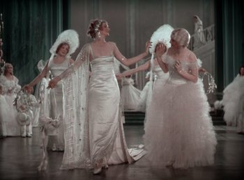Movie still from “King of Jazz” (1930), directed by Walter Lantz – A group of women dressed up in fancy gowns; Wide shot, High angle