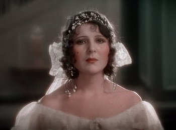 Movie still from “King of Jazz” (1930), directed by Walter Lantz – A woman in a white dress and a veil; Close Up shot, High angle