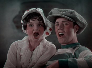 Movie still from “King of Jazz” (1930), directed by Walter Lantz – A man and a woman are singing together; Close Up shot, Low angle