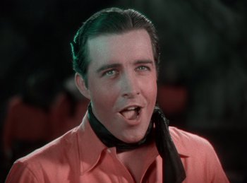 Movie still from “King of Jazz” (1930), directed by Walter Lantz – A person wearing a red shirt and a neck tie; Close Up shot, Low angle