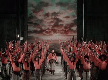 Movie still from “King of Jazz” (1930), directed by Walter Lantz – A large group of people are standing in front of a painting; Extreme Wide shot, High angle