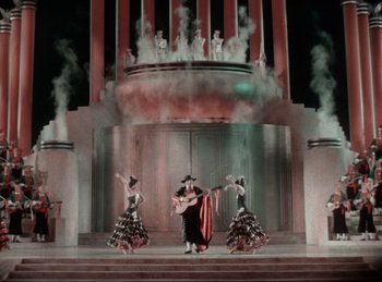 Movie still from “King of Jazz” (1930), directed by Walter Lantz – A group of people performing on a stage with smoke coming out of them; Extreme Wide shot, High angle