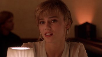 Movie still from “King of New York” (1990), directed by Abel Ferrara – A person wearing a white shirt; Close Up shot, Over the shoulder angle