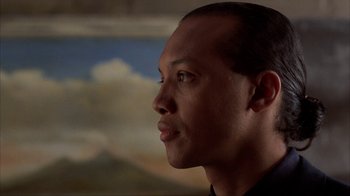 Movie still from “King of New York” (1990), directed by Abel Ferrara – A person wearing a black shirt; Close Up shot, Low angle