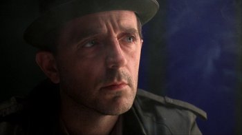 Movie still from “King of New York” (1990), directed by Abel Ferrara – A person wearing a hat; Close Up shot, Over the shoulder angle