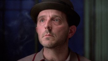 Movie still from “King of New York” (1990), directed by Abel Ferrara – A person wearing a hat; Close Up shot, Low angle