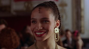 Movie still from “King of New York” (1990), directed by Abel Ferrara – A woman with a smile on her face; Close Up shot, High angle