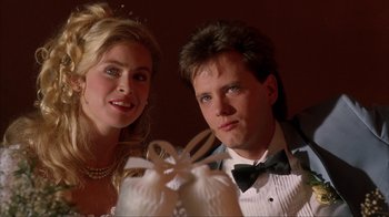 Movie still from “King of New York” (1990), directed by Abel Ferrara – A man and a woman posing for a picture; Close Up shot, Low angle