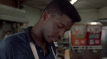 Movie still from “King of New York” (1990), directed by Abel Ferrara – A person with his eyes closed; Close Up shot, Low angle