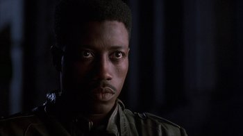 Movie still from “King of New York” (1990), directed by Abel Ferrara – A person wearing a jacket; Close Up shot, Low angle