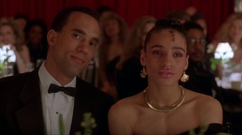 Movie still from “King of New York” (1990), directed by Abel Ferrara – A man and a woman are sitting together in a room; Close Up shot, Low angle