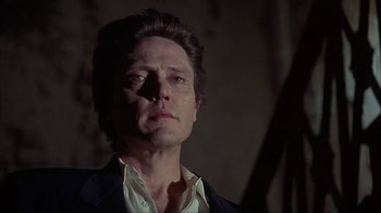 Movie still from “King of New York” (1990), directed by Abel Ferrara – A person wearing a suit and tie; Close Up shot, Low angle