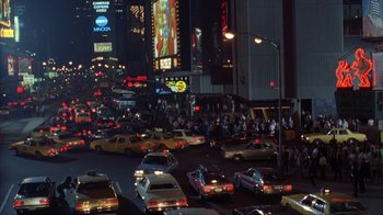 Movie still from “King of New York” (1990), directed by Abel Ferrara – A busy city street at night with a lot of traffic; Extreme Wide shot, High angle