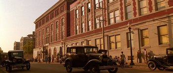 An old car is parked on the side of the street