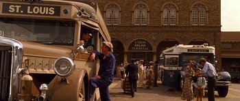 Movie still from “King of the Hill” (1993), directed by Steven Soderbergh – A group of people standing next to an old bus; Wide shot, Low angle
