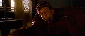 A man in a uniform sitting in a chair