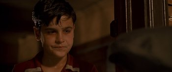 Movie still from “King of the Hill” (1993), directed by Steven Soderbergh – A young boy is looking into the camera; Close Up shot, Over the shoulder angle