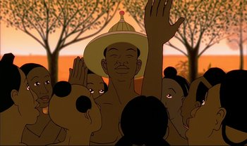 Movie still from “Kirikou and the Sorceress” (1998), directed by Raymond Burlet – A man in a hat is waving to the crowd; Close Up shot, Low angle