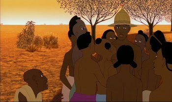 Movie still from “Kirikou and the Sorceress” (1998), directed by Raymond Burlet – A group of men standing around a tree; Medium shot, Over the shoulder angle