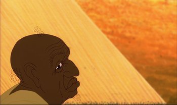 Movie still from “Kirikou and the Sorceress” (1998), directed by Raymond Burlet – An old man with a beard is looking at the ground; Extreme Close Up shot, Low angle