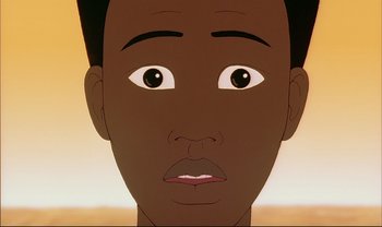 Movie still from “Kirikou and the Sorceress” (1998), directed by Raymond Burlet – An animated face of a young man with brown eyes; Extreme Close Up shot, Overhead angle