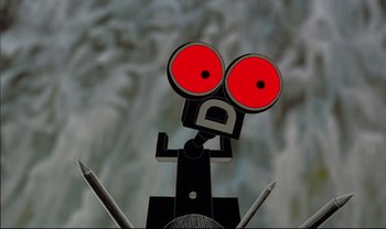 Movie still from “Kirikou and the Sorceress” (1998), directed by Raymond Burlet – An image of a robot with red eyes; Extreme Close Up shot, Low angle