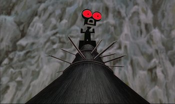 Movie still from “Kirikou and the Sorceress” (1998), directed by Raymond Burlet – A cartoon of an evil looking monster on top of a building; Extreme Close Up shot, Low angle