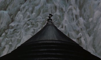 Movie still from “Kirikou and the Sorceress” (1998), directed by Raymond Burlet – A camera on the top of a black umbrella in front of a waterfall; Extreme Wide shot, Low angle