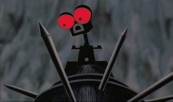 Movie still from “Kirikou and the Sorceress” (1998), directed by Raymond Burlet – View of a robot's head with three sharp metal spikes; Extreme Close Up shot, Low angle
