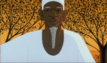 Movie still from “Kirikou and the Sorceress” (1998), directed by Raymond Burlet – An animated character is shown in front of a tree background; Close Up shot, Low angle
