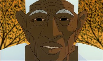 Movie still from “Kirikou and the Sorceress” (1998), directed by Raymond Burlet – An animated face of an african american man; Extreme Close Up shot, Low angle