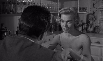 Movie still from “Kiss Me Deadly” (1955), directed by Robert Aldrich – An old black and white photo of a man and a woman; Close Up shot, Over the shoulder angle