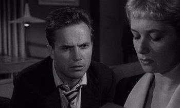 Movie still from “Kiss Me Deadly” (1955), directed by Robert Aldrich – A black and white photo of a man and a woman; Close Up shot, Over the shoulder angle