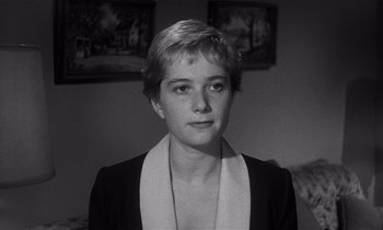 Movie still from “Kiss Me Deadly” (1955), directed by Robert Aldrich – Black and white photograph of a woman in a room; Close Up shot, High angle