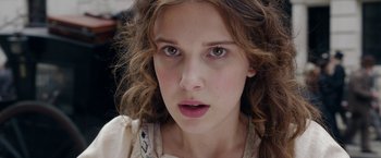 Movie still from “Enola Holmes 2” (2022), directed by Harry Bradbeer – A person with long brown hair; Close Up shot, Low angle